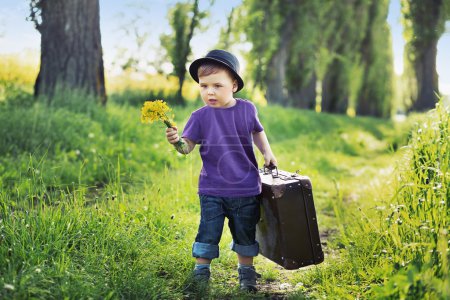 Young boy with huge suitcase