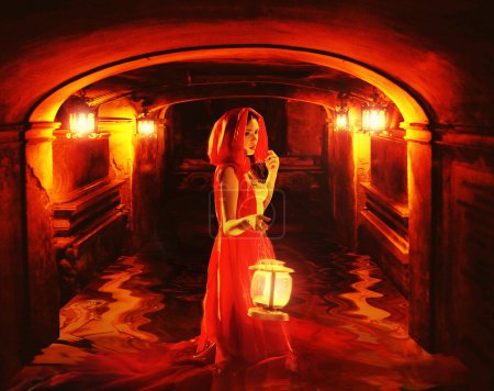 Romantic lady in red holding a lantern in a dark dungeon