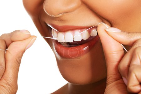 Attractive woman with dental floss. Closeup.