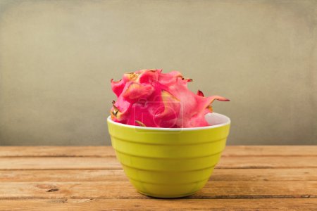 Dragon fruit pitaya in bowl on wooden table