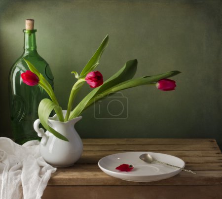 Still life with red tulip and white plate