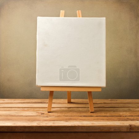 Background with blank canvas on wooden table