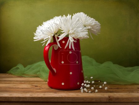 Still life with chrysanthemum flowers in red jug
