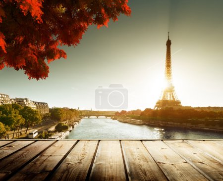 wooden deck table and Eiffel tower in autumn