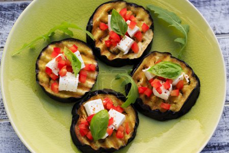 Grilled eggplant with feta cheese, red peppers and basil 