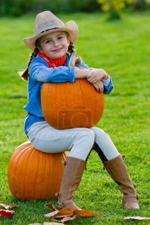 Harvest of pumpkins, autumn in the garden - the lovely girl and large pumpkins