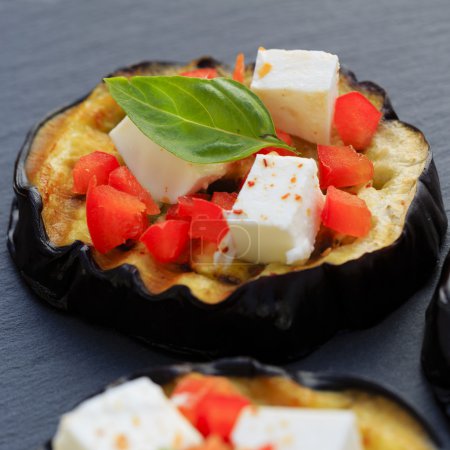 Grilled eggplant with feta cheese, red peppers and basil 