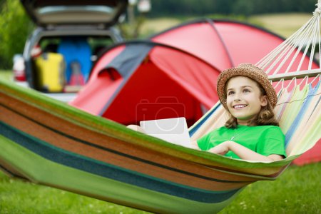 Summer in the tent - young girl with family on the camping