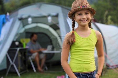 Summer in the tent - young girl with family on the camping