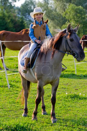 Horseback riding - lovely cowgirl is riding a horse
