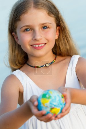 Summer travel concept - Globe on child hands