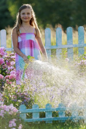 Summer fun, girl watering flowers