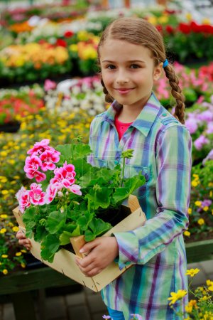 Planting, garden flowers - girl shopping plants and flowers in garden center