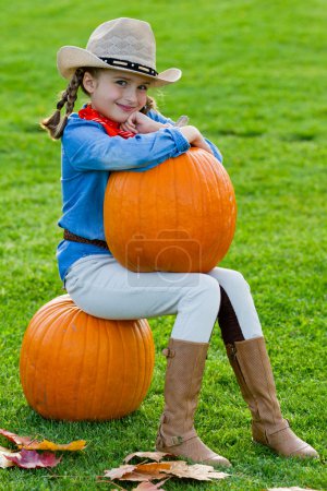 Harvest of pumpkins, autumn in the garden - the lovely girl and large pumpkins
