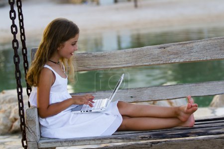 Girl with netbook - young girl with netbook resting on the beach