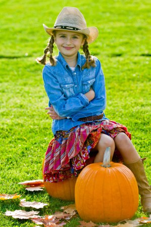 Autumn harvest -  lovely girl and large pumpkins
