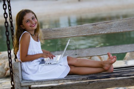 Girl with netbook - young girl with netbook resting on the beach