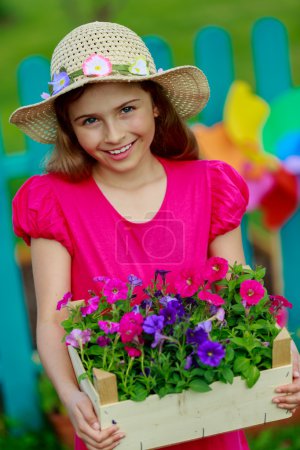 Gardening, planting - lovely girl  working in flowers garden