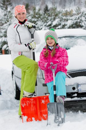 Winter, snow, car - family  shoveling the car of snow