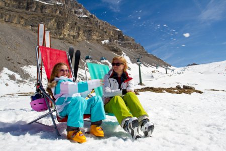 Ski, snow, sun and winter holidays - skiers in Dolomites