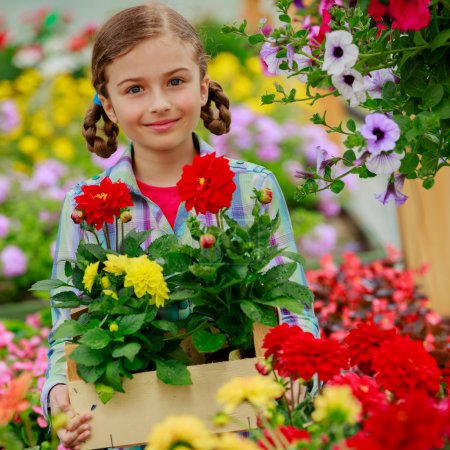 Planting, garden flowers - Lovely girl with flowers