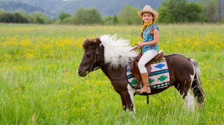Horseback riding - lovely cowgirl is riding a pony