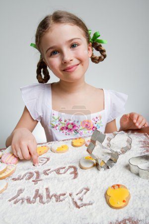 Happy Easter - lovely girl making easter cookies