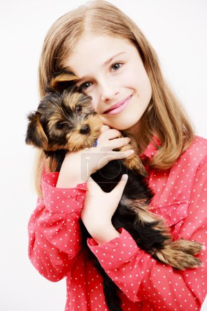 Young girl with  puppy, cute Yorkshire terrier  - best friends
