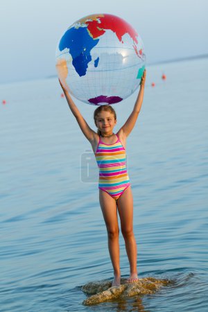 Summer game, young girl playing in the sea