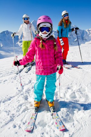 Skiing, winter fun - happy skiers on ski holiday