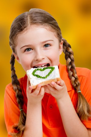 Spring sandwich - lovely girl eating cottage cheese with chives on bread
