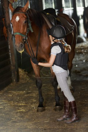 Equestrian girl on ranch ready to horseriding