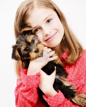Young girl with  puppy, cute Yorkshire terrier  - best friends