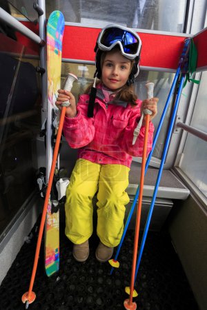 Ski, ski cable car, skier, ski resort - happy girl in cable car