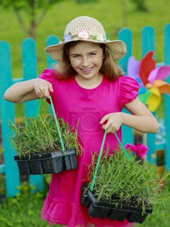 Gardening, planting - lovely girl with lavender seedlings