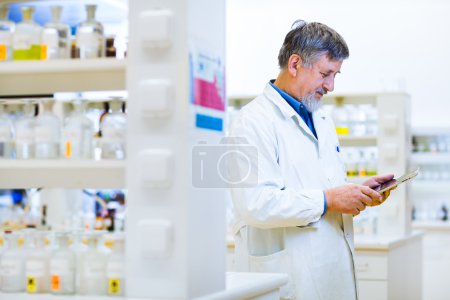 Senior scientist using his tablet computer at work