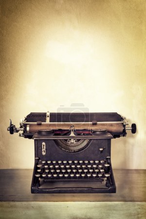 Vintage Typewriter on Old Desk with Grunge Background