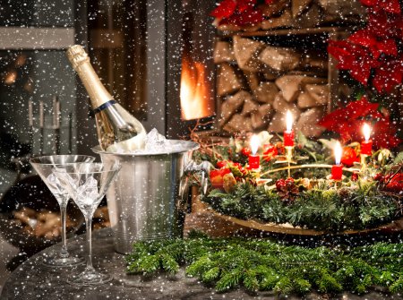 Bottle of champagne, glasses and fireplace