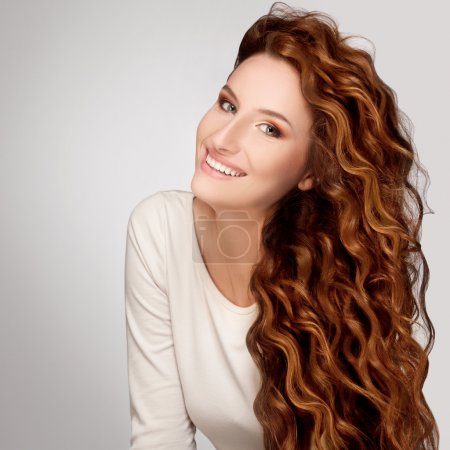 Red Hair. Woman with Beautiful Curly Hair