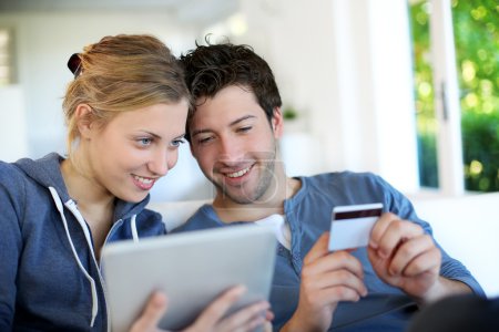 Happy young couple doing shopping on internet