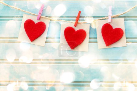 Hand-crafted felt hearts hanging with clothespins