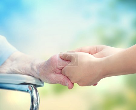Senior woman holding hands with caretaker