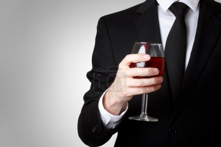 Young man holding a glass of red wine