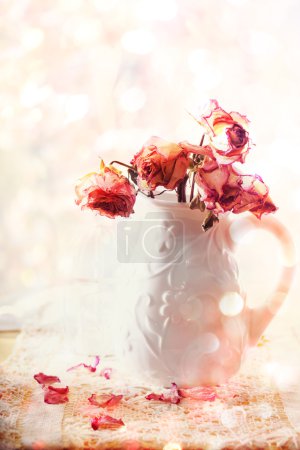 Dried roses in vase 