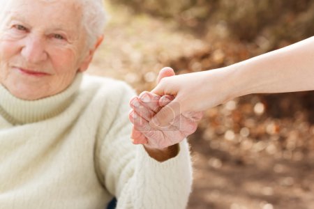 Senior woman holding hands