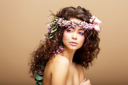 8 March. Springtime. Beauty Woman with Wreath of Flowers over beige