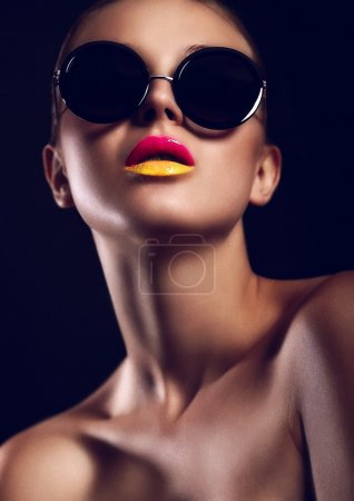 Woman with bright make-up in sun glasses
