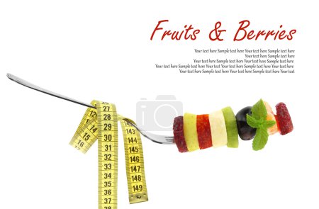 Fresh mixed slices of fruits on a fork with measuring tape
