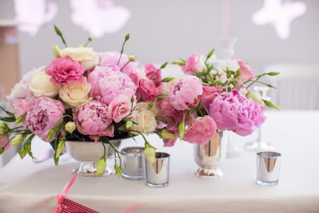 Beautiful bright bouquet of peony on the wedding table in vase