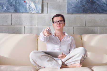 Woman using tv remote